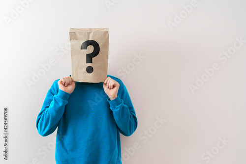 a person with a paper bag on the head with question mark, sign symbol of problem photo