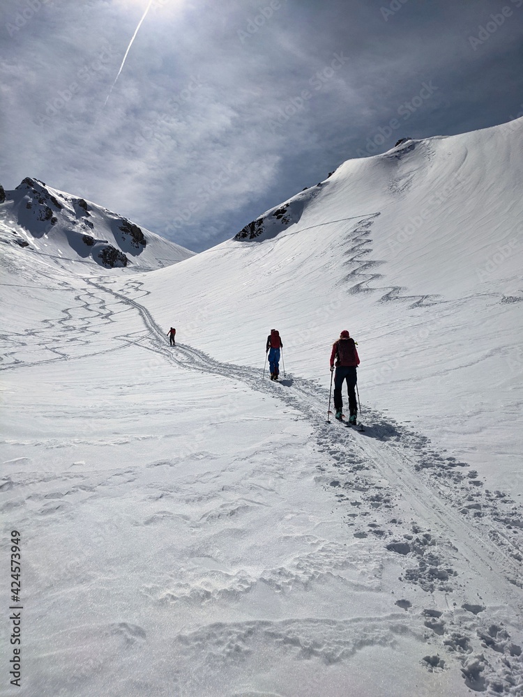 ski tour in the swiss mountains. mountaineering in the alps of glarus. Trail of ascent in a valley. Winter landscape, ski
