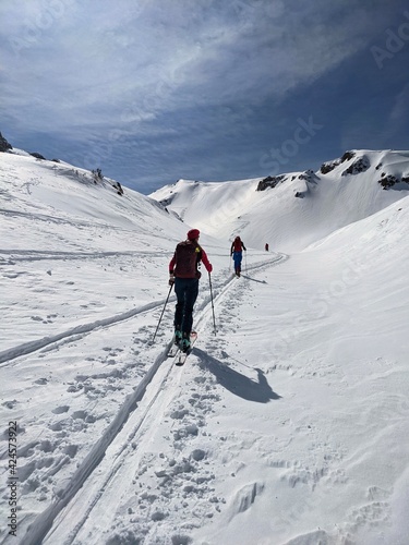 Hiking on skis on the great swiss mountains. Fantastic view in winter time. Ski touring couple. Ski touring track
