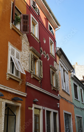 Colorful facades of vivid colors on masonry residential buildings and stone details from the time of the Roman Empire