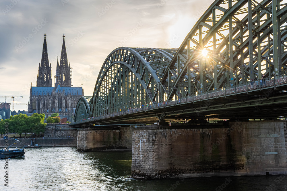 COLOGNE, GERMANY, 23 JULY 2020 Sunburst sunset right on the Hohenzollern Bridge, Cologne Cathedral on the background