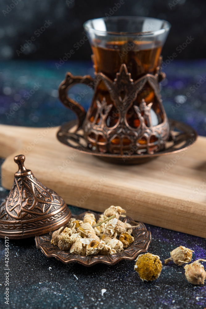 Vertical photo of Fragrant tea behind of various herbs