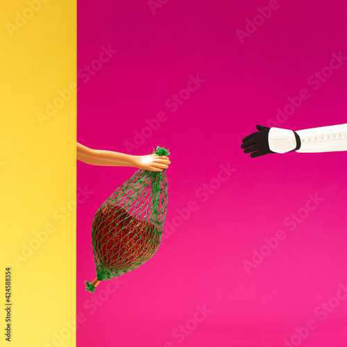Obraz na plátně Minimal arrangement of female doll hand holding small bag with heart in it