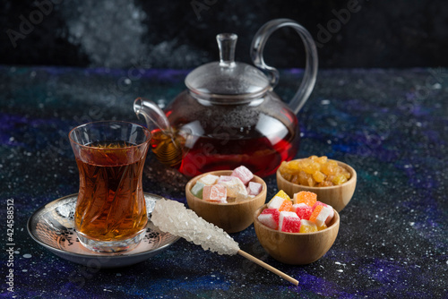 Tea set with Turkish delights on blue background photo