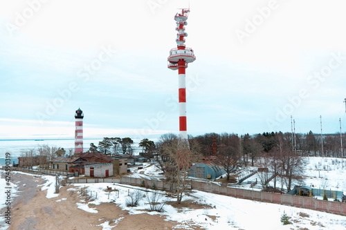 white and red lighthouswhite and red lighthouse on the beach in wintere on the beach in winter