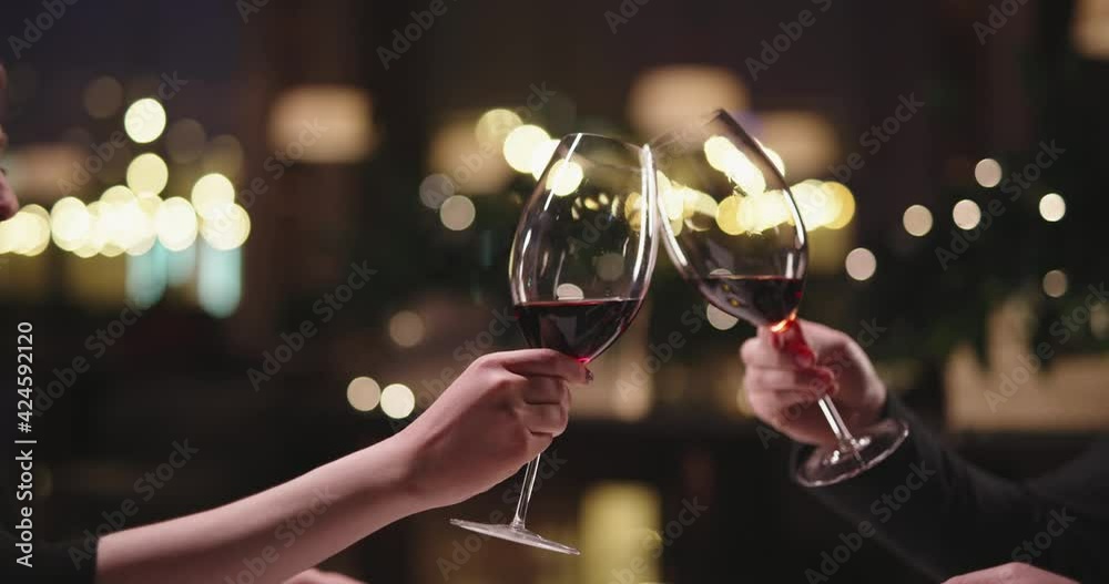 Joyful couple having a romantic dinner at a fancy restaurant. People enjoying their date, drinking wine, eating and chatting 4k footage