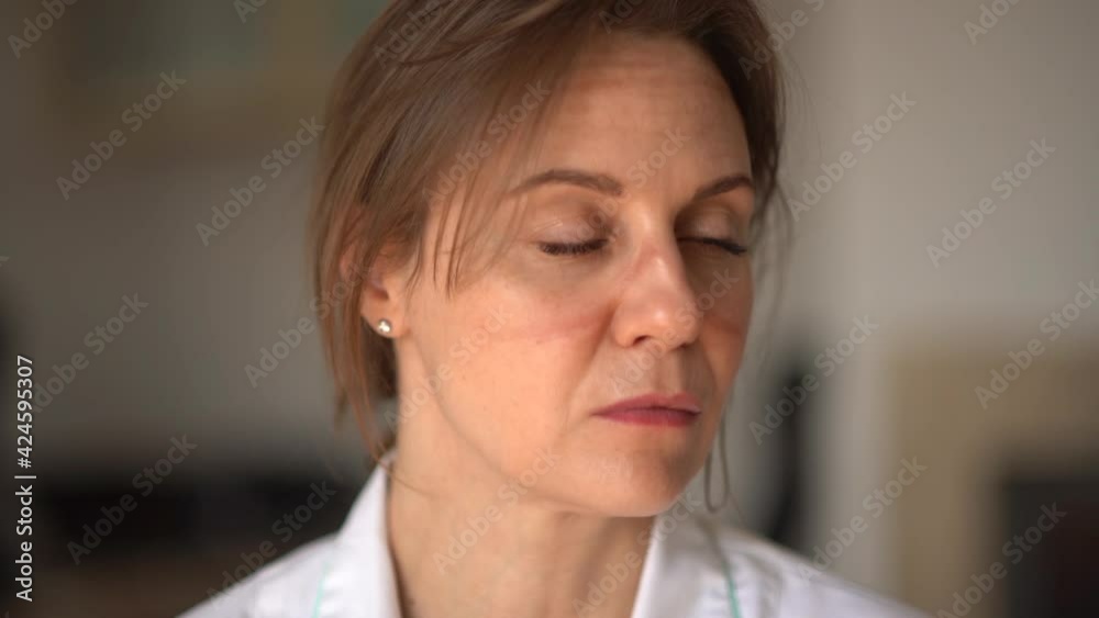 Portrait of a tired and sad female doctor with traces of a mask on her face. The work of doctors during the epidemic coronavirus covid-19 Portrait of a tired and sad female doctor with traces of a mask on her face. The work of doctors during the epidemic coronavirus covid-19