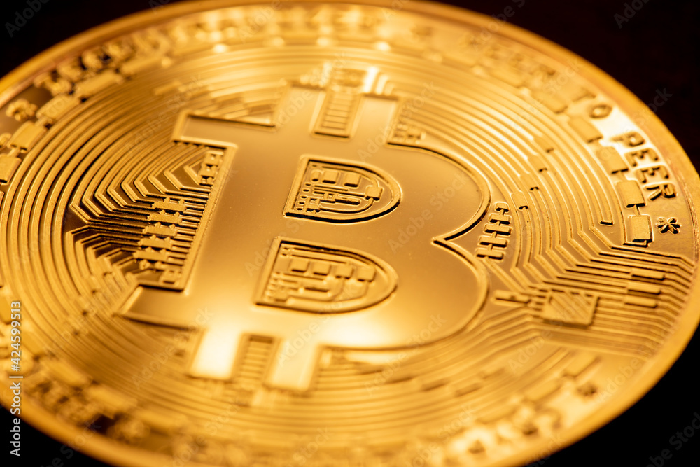 Golden bitcoin coin closeup. Bitcoins. Physical bit coins. Digital currency. Cryptocurrency mining concept. Golden bitcoin coin closeup. Bitcoins. Physical bit coins. Digital currency. Cryptocurrency mining concept.