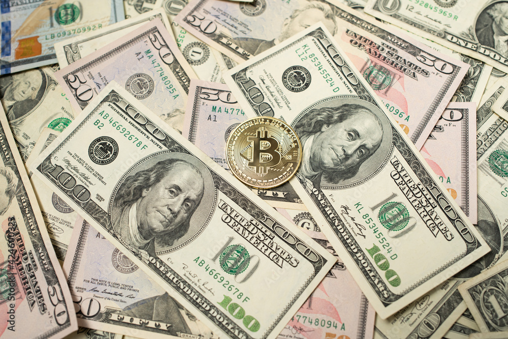 Bitcoin coin on top of Dollar Bills and Banknotes, Digityl Crypto currency and Fiat Money. USD, United States Dollar Money and Cash Bitcoin coin on top of Dollar Bills and Banknotes, Digityl Crypto currency and Fiat Money. USD, United States Dollar Money and Cash