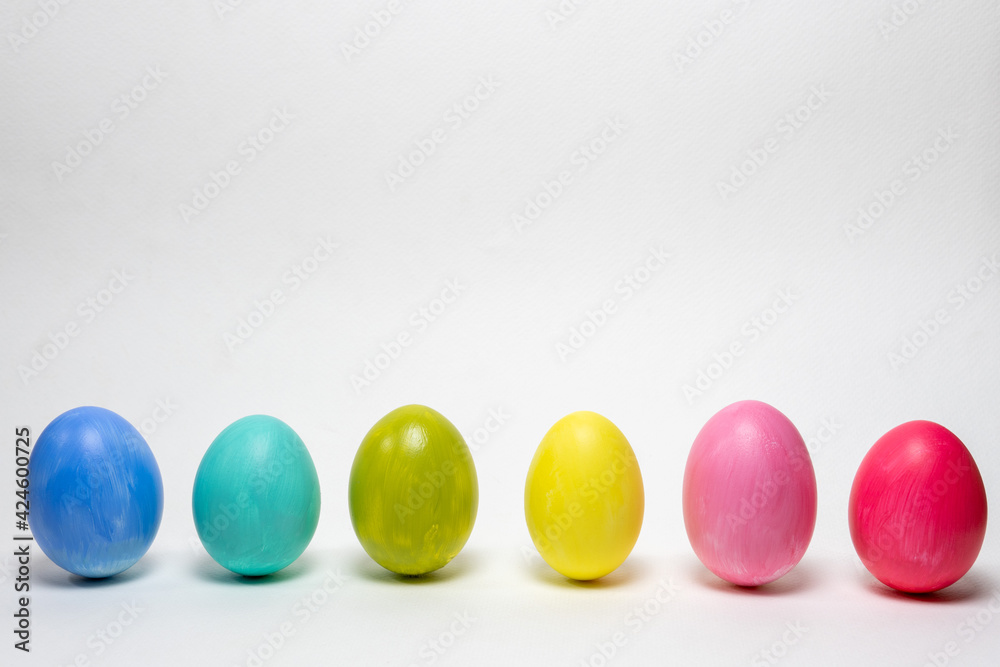 Six colorful eggs on white background.  Standing up. Creative Easter background