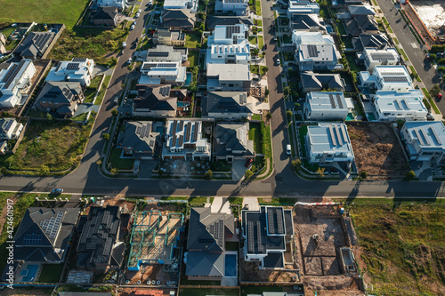 High angle aerial view of modern upmarket houses under construction many with rooftop solar, Sydney, Australia.