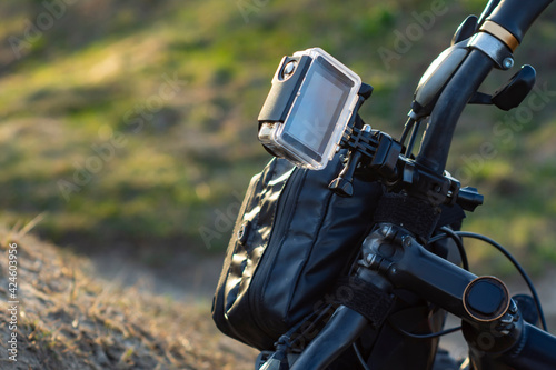Action Camera on a bike with a bikepacking bag in a waterproof case against the backdrop of nature.