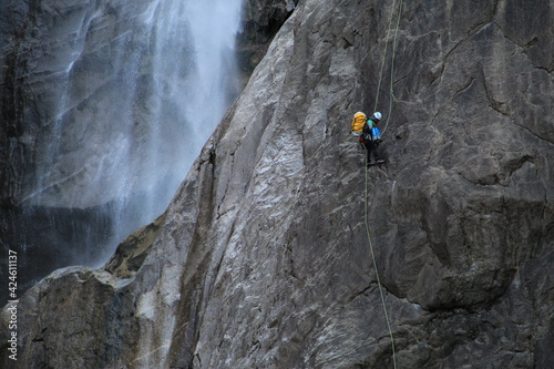 Yosemite rock climber beside mountain waterfall