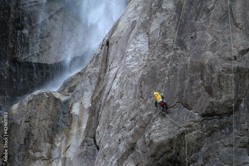 Fototapeta Naklejka Na Ścianę i Meble -  Yosemite rock climber beside mountain waterfall