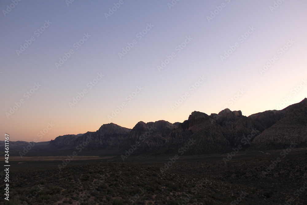 Mountain silhouette desert sky at sunset