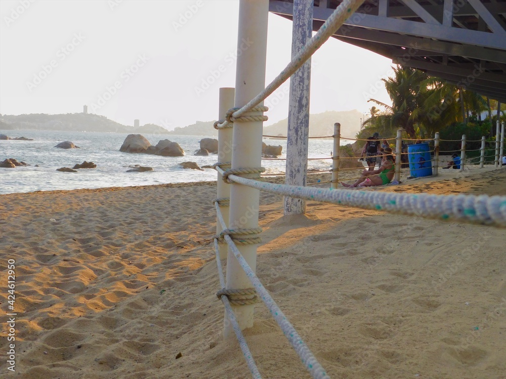 Fototapeta premium a rope fence on the beach in the afternoon