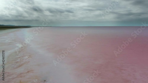 A salt or saline lake is a landlocked body of water that has a concentration of salts and other dissolved minerals significantly higher than most lakes.Pink vibrant colour alkalic carbonate solid red  photo