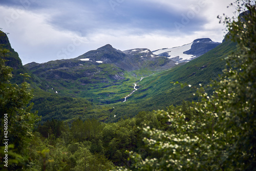 Snowy peaks with waterfall in Geiranger