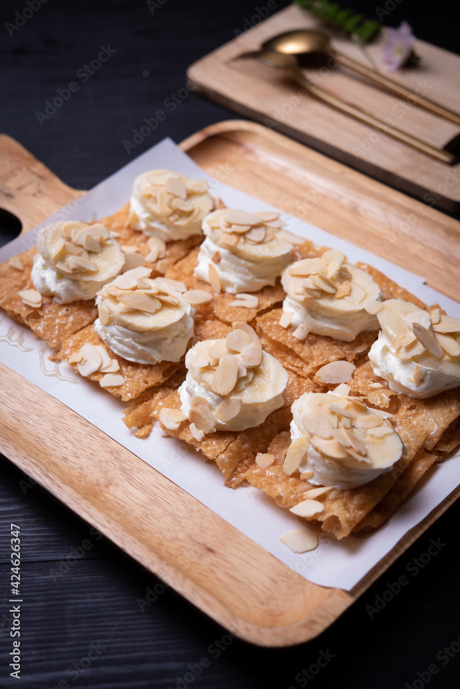 Fototapeta premium Roti desserts with whipped cream and nut on wood