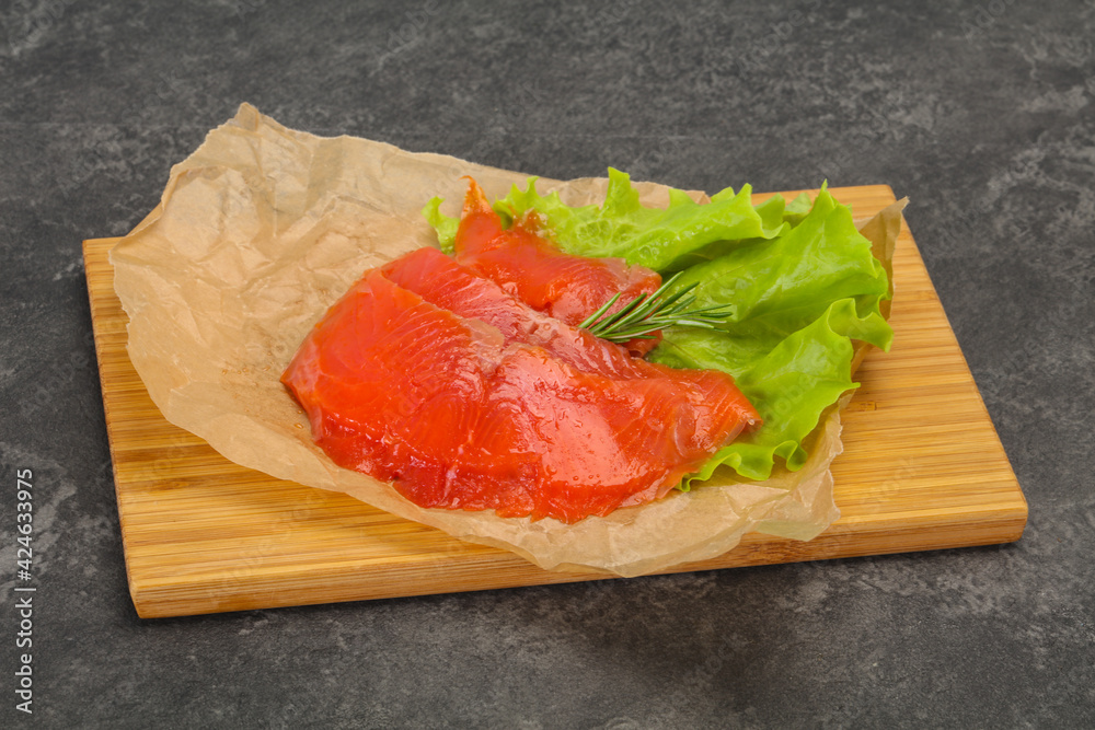 Sliced salmon fillet served rosemary