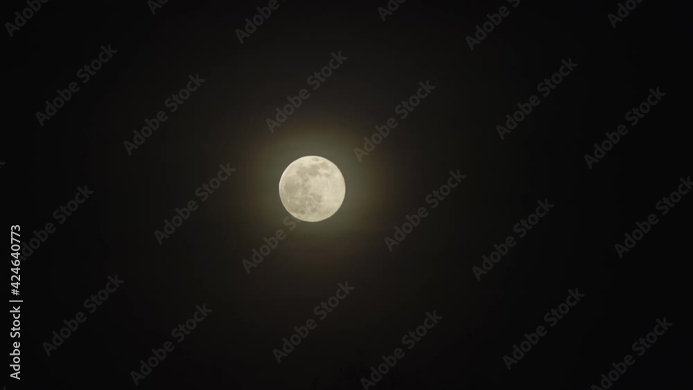 Medium shot of the full moon. Left side on the frame. Full moon with glow. Medium shot of the full moon. Left side on the frame. Full moon with glow.