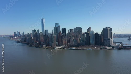 Wallpaper Mural An aerial view of New York Harbor on a sunny day with blue skies. The drone camera facing lower Manhattan dolly out over the calm waters with no boats or any activity. Torontodigital.ca