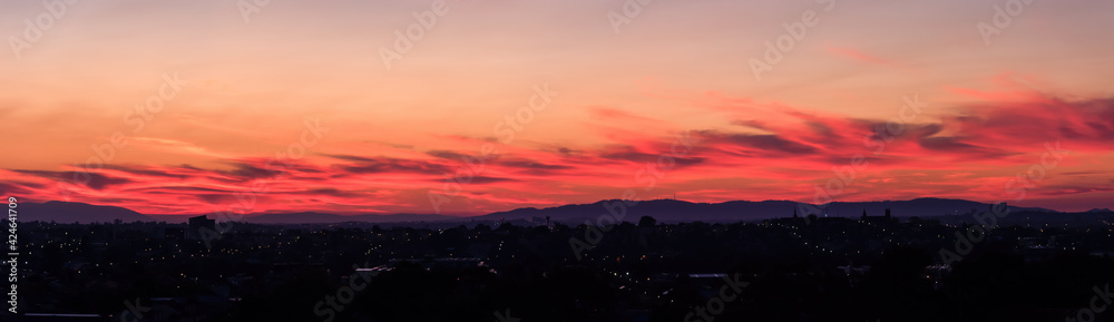 A panoramic sky landscape over the suburbs of Melbourne, Australia with Mt Dandenong on the horizon