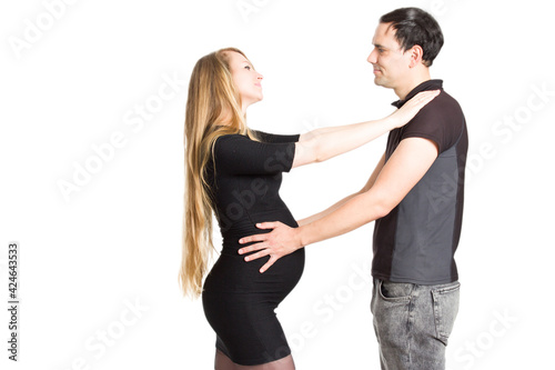 Photo of pregnant blonde and a man standing on a white isolated background
