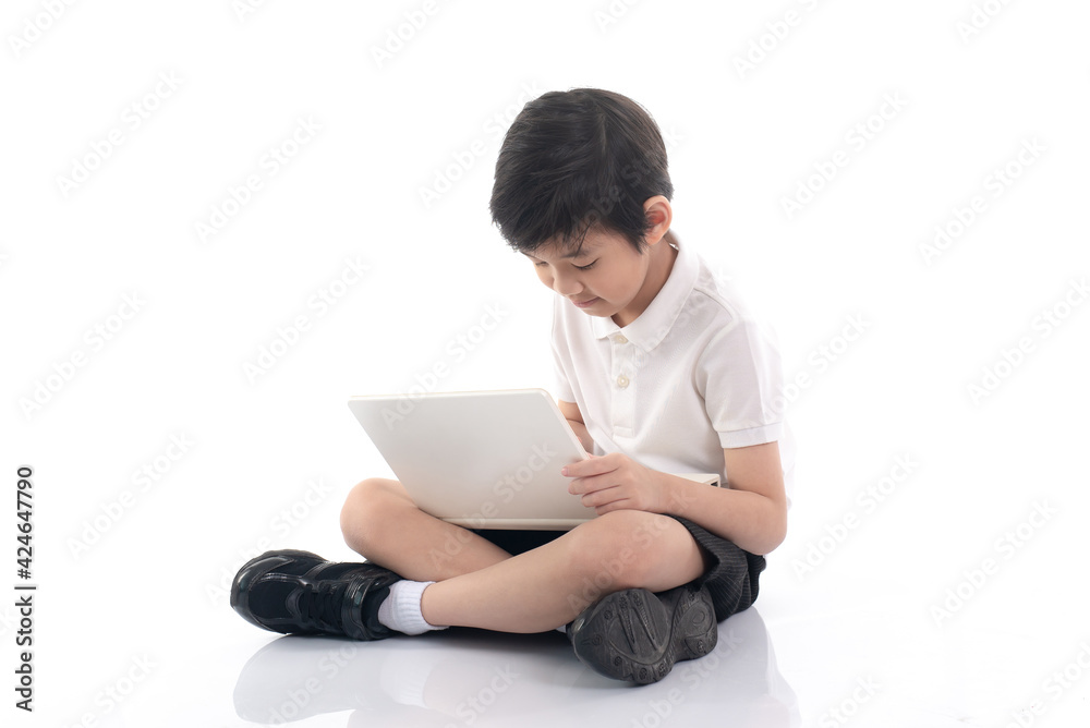 Cute Asian child sitting and using laptop on white background isolated Cute Asian child sitting and using laptop on white background isolated
