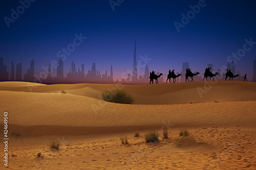 Travel on caravan near Dubai desert with city panorama at sunset