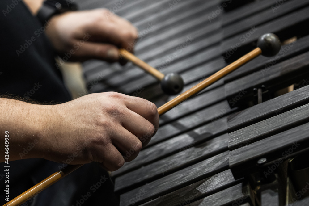 Hands of a musician playing the xylophone in black and white 