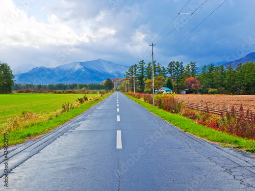 The roadside of Obihiro (Hokkaido), surrounded by mountains and Agricultural land. photo