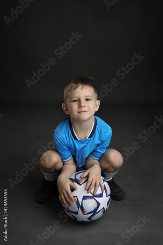 Boy with soccer ball in blue uniform