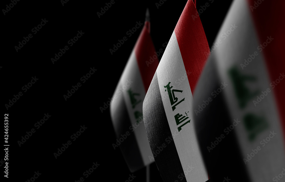 Small national flags of the Iraq on a black background Stock Photo