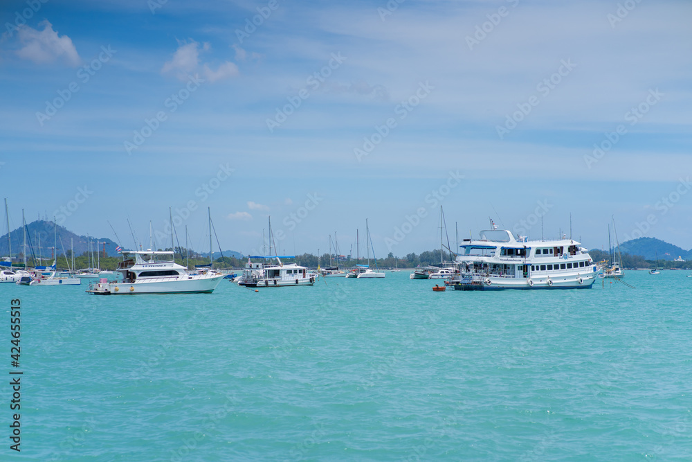 Different white yachts and ships in the azure bay