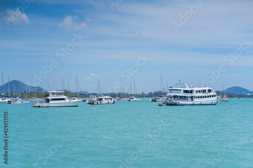 Different white yachts and ships in the azure bay © Dima