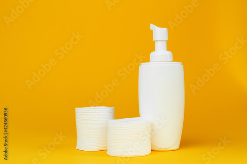 Stack of cotton discs and skicare cosmetic bottle © fotofabrika