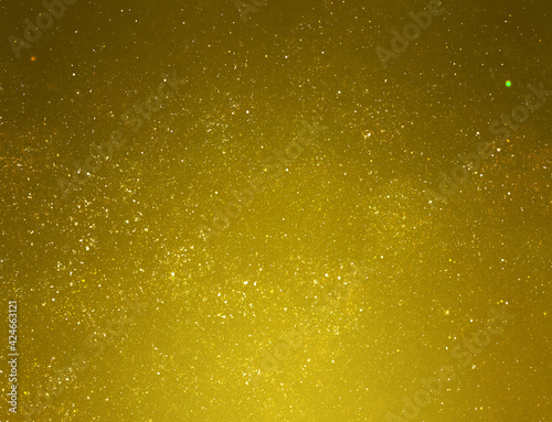 Golden starry glitter background. Gold glitter lights