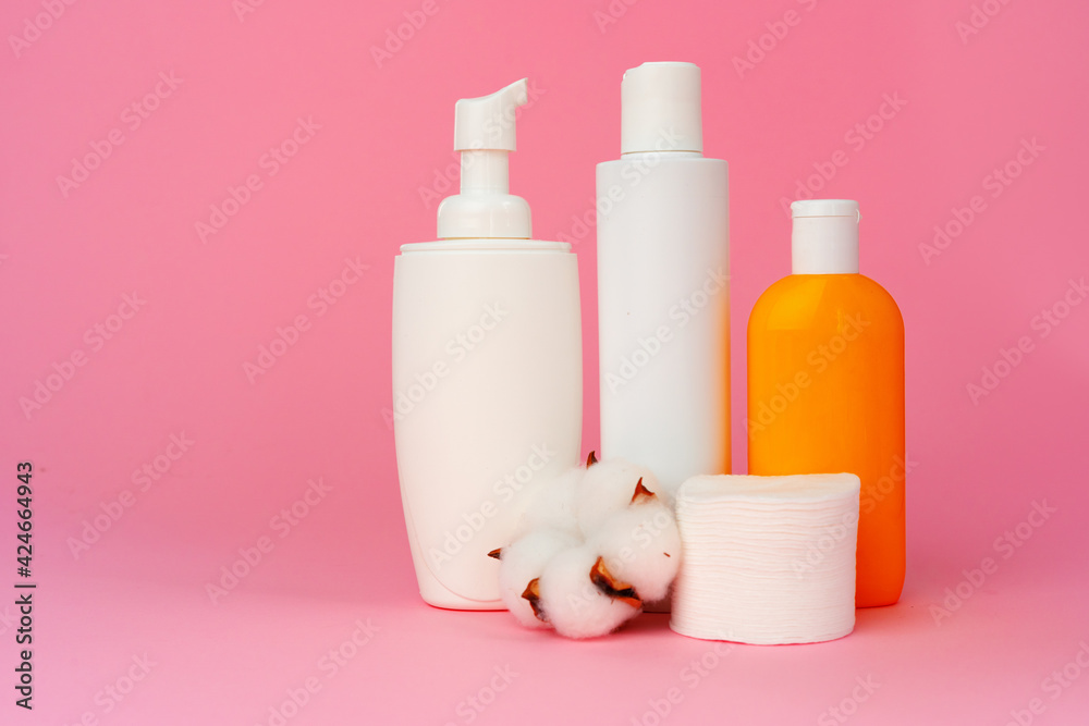 Stack of cotton discs and skicare cosmetic bottle