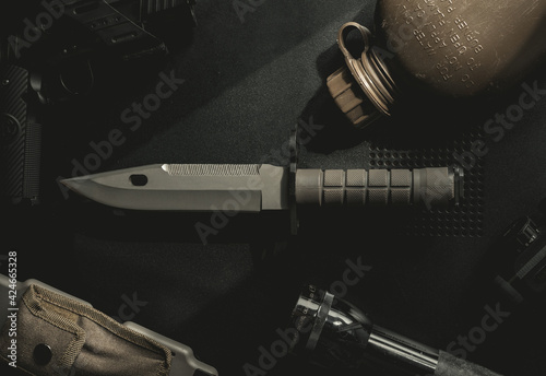 Canvas Print Top down photo of a knife, bayonet, tabletop.