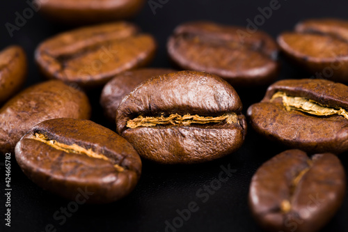 whole and flavorful coffee beans scattered in a chaotic order
