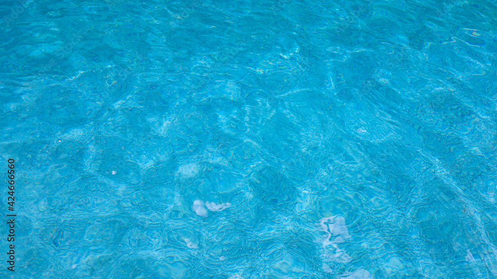 Abstract pool water.  Swimming pool bottom caustics ripple and flow with waves background surface of blue swimming pool