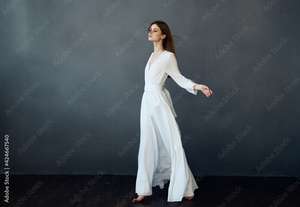 Woman in white dress dance performance luxury glamor gray background Woman in white dress dance performance luxury glamor gray background