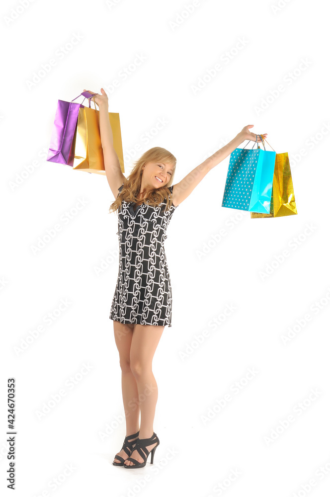 Beautiful woman with a lot of shopping bags. isolated on white