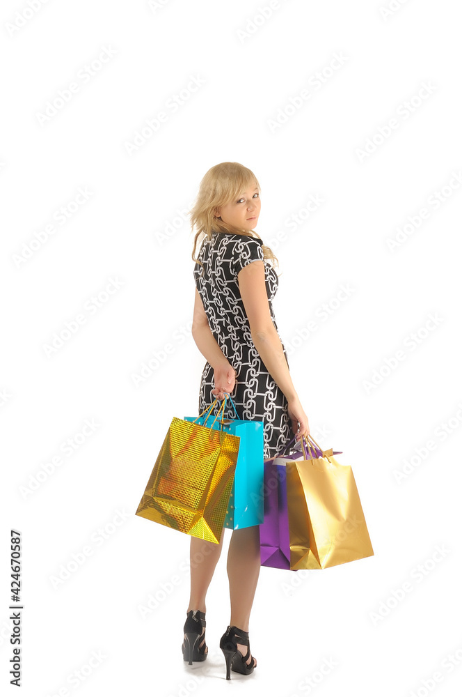 Beautiful woman with a lot of shopping bags. isolated on white