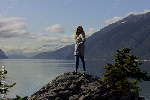 Young woman stands on the mountain