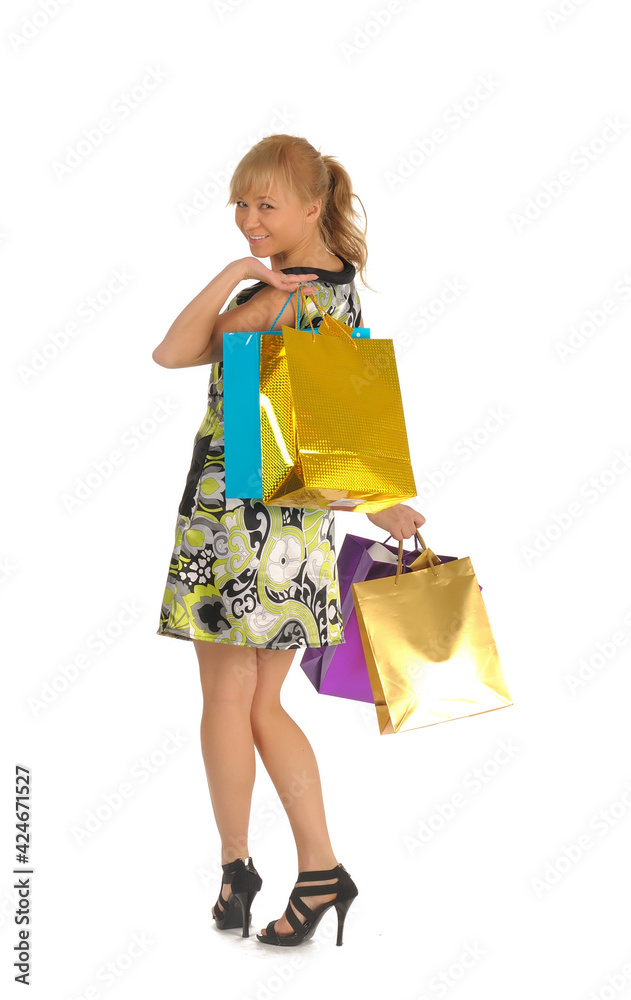 Beautiful woman with a lot of shopping bags. isolated on white