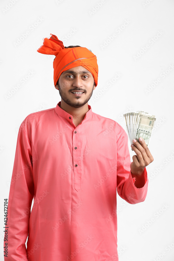 Young Indian farmer posing with currency on white background. Young Indian farmer posing with currency on white background.