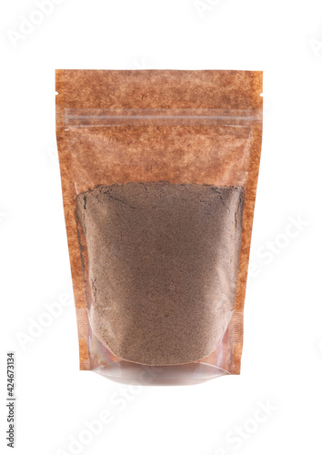 Cocoa powder in a brown paper bag. Doy-pack with a plastic window for bulk products. Close-up. White background. Isolated.
