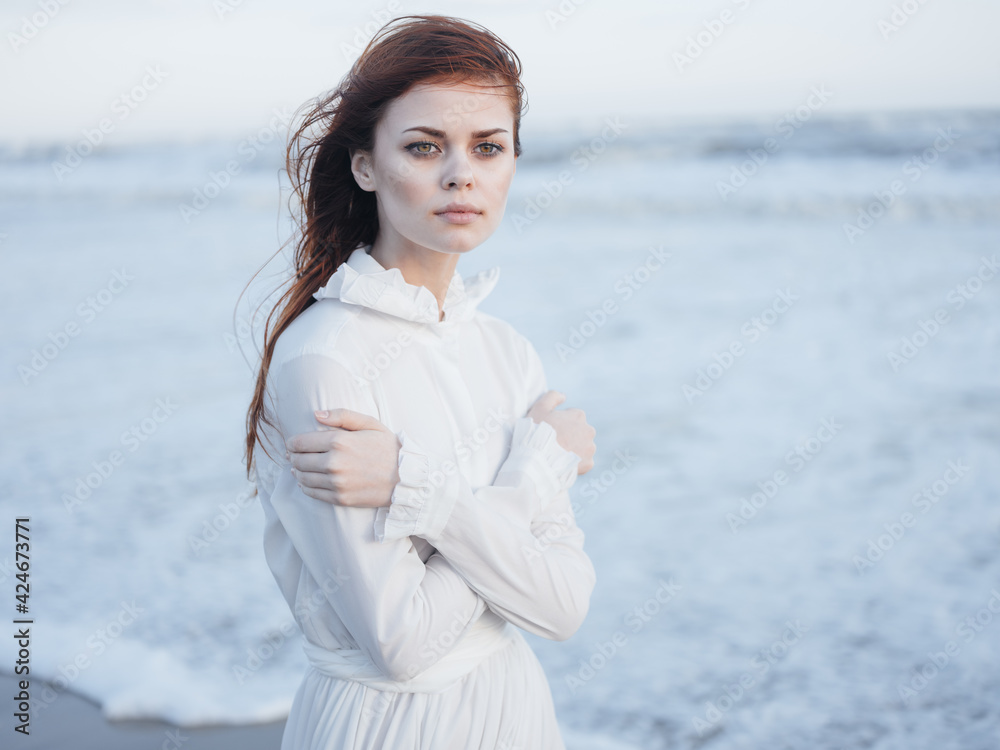 Woman in white dress on the ocean waves beach nature Woman in white dress on the ocean waves beach nature